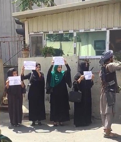 아프가니스탄 여성 4명이 17일 카불에서 탈레반을 향해 여성의 권리를 요구하는 항의 시위를 벌이고 있다. 여성들은 히잡 차림이다. 여성들의 옆에는 무장한 탈레반이 서있다. [트위터 캡처]